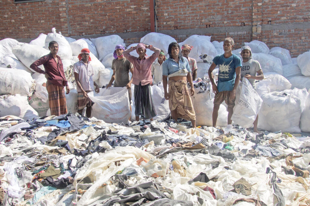Men sorting leftovers after production in Dhaka