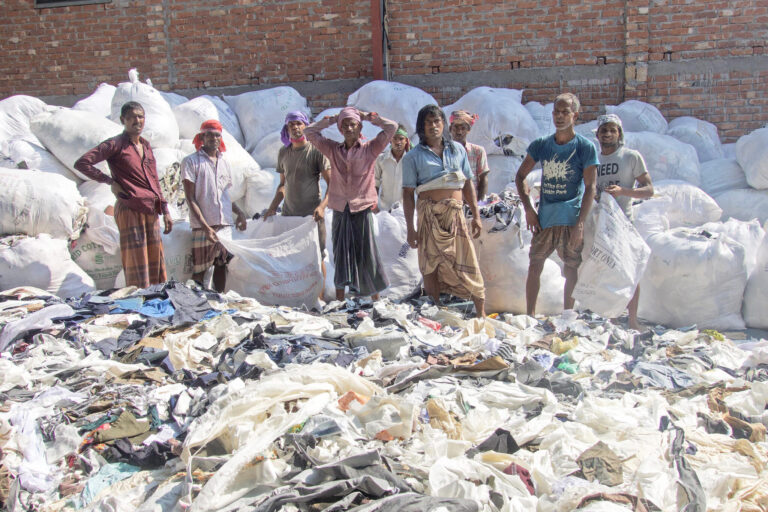 Men sorting leftovers after production in Dhaka